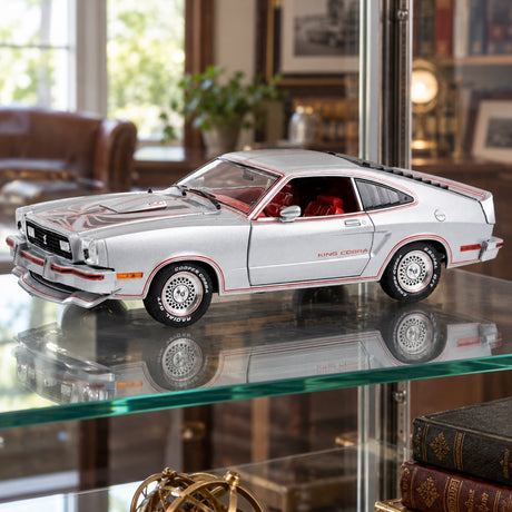 Model Ford Mustang II King Cobra – stříbrná metalíza s červenými a černými pruhy – 1:18 Greenlight – ilustrační foto (AI)